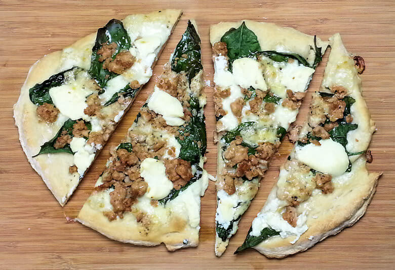 Picture of cut White Spinach and Three Cheese Pizza